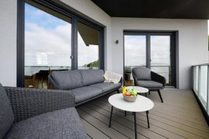 a living room with a couch and two chairs and a table at Seaside in Laboe