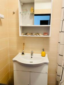 y baño con lavabo y espejo. en Dream Sury Apartment - metrou Leonida, spital Obregia, en Bucarest