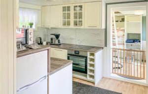a kitchen with white cabinets and a counter top at Amazing Home In Gyttorp With Wifi And 3 Bedrooms in Gyttorp