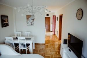 a living room with a table and a dining room at Apartman Hana in Gornja Toplica