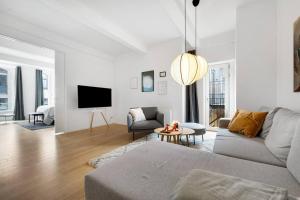 a living room with a couch and a tv at Boutique apartment in Citycenter in Copenhagen