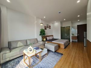 a living room with a couch and a bed at The West Lake Serenity'N Homestay Ha Noi 462 in Hanoi +8 photos