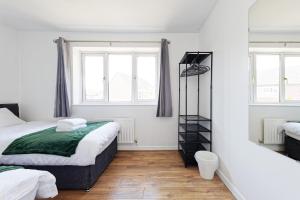 a bedroom with two beds and two windows at Comfortable Home in Kent, Sleeps 6 - Parking Available in Kent