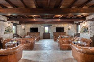 a large room with brown leather chairs and tables at Villa Torre Delle Rose - Firenzuola, Private Pool, Ac, Privacy in Castelvecchio