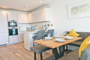 a kitchen and dining room with a wooden table and chairs at Sea view apartment, first floor in Saint Merryn