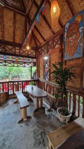 a room with a table and a bench in a building at Enter Point in Bukit Lawang