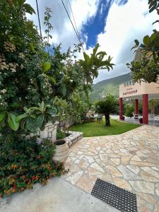 a garden with plants and flowers in front of a building at Hotel Odyssion in Vasiliki