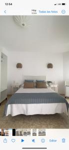 a bedroom with a bed and two tables at Hostal Andalucia in Nerja