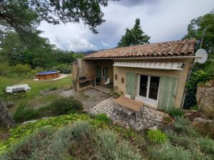 a small house with a picnic table in front of it at Gîte Le Petit Jas in Villeneuve