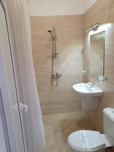 a bathroom with a toilet and a sink and a shower at студия ЛИЛИЯ in Tsarevo +118 photos