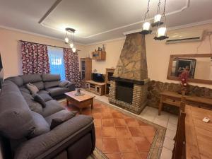a living room with a couch and a fireplace at Chalet , a 6km de la playa in Chiclana de la Frontera