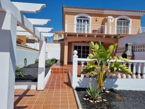 a house with a staircase in front of it at Villa Maracay-Caleta de Fuste-fiber optic 600mb in Caleta De Fuste