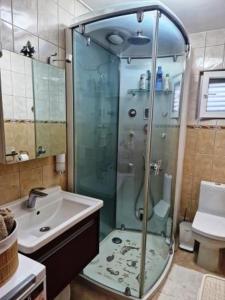 a bathroom with a glass shower and a sink at Apartment CHARLY in Supetar +44 photos