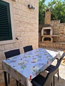a table and chairs with a table and an oven at Apartment CHARLY in Supetar