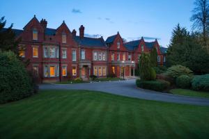 a large red brick house with a driveway at Delta Hotels by Marriott Preston in Preston