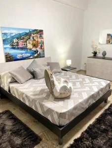 een slaapkamer met een bed met een schilderij aan de muur bij Cusumano house in Trappeto