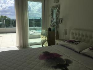 a bedroom with a large bed and a large window at Suite Luxury Seaview in Misano Adriatico