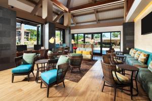 a lobby of a hotel with chairs and tables at Sheraton Kauai Resort Villas in Koloa