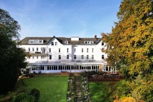 an exterior view of a large white house at Delta Hotels by Marriott York in York