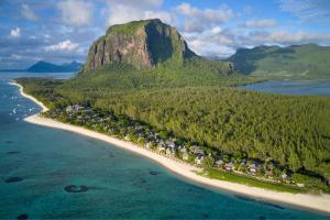 an island in the ocean with a mountain in the background at JW Marriott Mauritius Resort in Le Morne