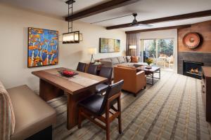 a living room with a dining and living room with a fireplace at Sheraton Lakeside Terrace Villas at Mountain Vista, Avon, Vail Valley in Avon