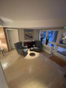 a living room with two chairs and a table at Hotel Schwarzwälder Hof Achern in Achern