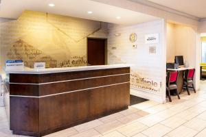 a hotel lobby with a reception counter and a desk at Fairfield Inn & Suites by Marriott St Louis Chesterfield in Chesterfield
