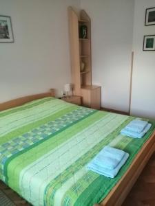 a bedroom with a bed with towels on it at NANA apartment in Ohrid