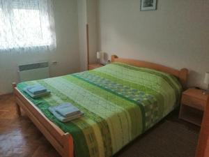 a bedroom with a bed with two towels on it at NANA apartment in Ohrid +19 photos