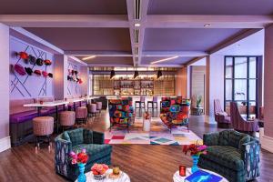 a lobby with a bar and some chairs and tables at Hotel Colee, Atlanta Buckhead, Autograph Collection in Atlanta