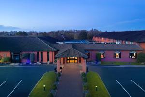 an aerial view of a house with a tennis court at Delta Hotels by Marriott Northampton in Northampton