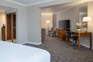 a hotel room with a bed and a desk and a television at Delta Hotels by Marriott Northampton in Northampton