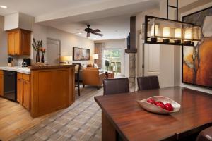 a kitchen and living room with a table and a dining room at Sheraton Mountain Vista Villas, Avon / Vail Valley in Avon