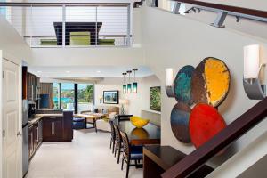 an open kitchen and living room with a staircase at The Westin St. John Resort Villas in Saint John