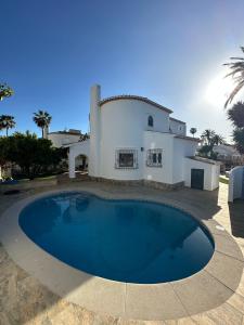 a large swimming pool in front of a house at La Duna de Denia in Denia