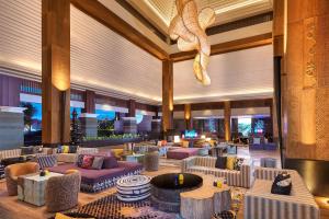 a lobby of a hotel with couches and tables at Marriott's Bali Nusa Dua Terrace in Nusa Dua