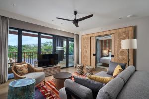 a living room with a couch and a television at Marriott's Bali Nusa Dua Terrace in Nusa Dua