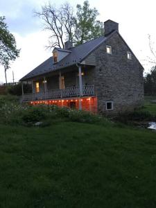 a large stone house with lights on the side of it at Springhouse 1803 in Hagerstown