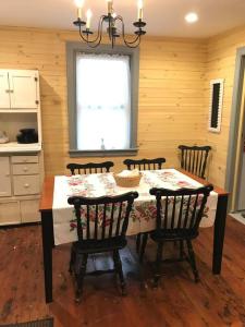 a dining room with a table and four chairs at Springhouse 1803 in Hagerstown