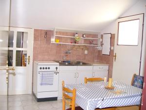 a kitchen with a table and a sink and a stove at Apartmán Jeseník Česká Ves in Česká Ves