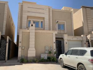 a white car parked in front of a house at شقق العارض (2) in Riyadh
