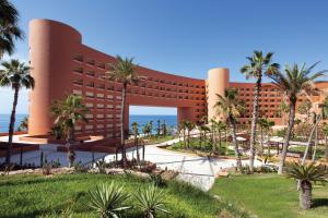 a resort with palm trees in front of it at The Westin Los Cabos Resort Villas in San José del Cabo