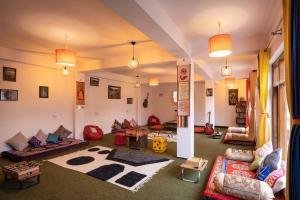 a large living room with couches and a rug at Zostel Spiti in Kaza