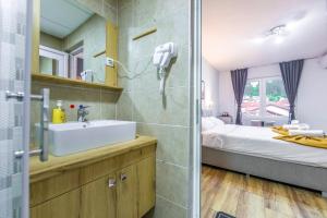 a bathroom with a sink and a bed and a mirror at Villa Trofej in Ohrid +61 photos