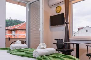 a room with a bed with a view of a balcony at Villa Trofej in Ohrid