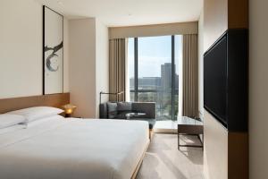 um quarto de hotel com uma cama e uma grande janela em Fairfield by Marriott Xi'an Chanba em Xian
