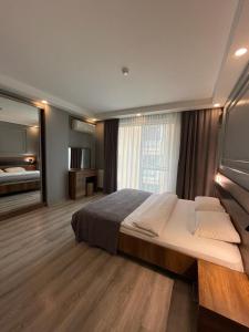 a large bedroom with a large bed and a mirror at On4 Rooms & Suites in Istanbul
