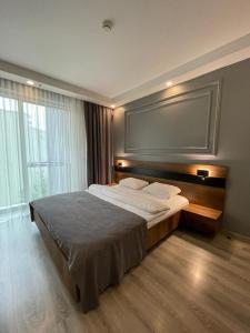 a bedroom with a large bed and a large window at On4 Rooms & Suites in Istanbul