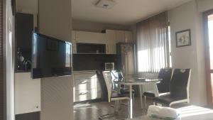 a kitchen with a table and chairs and a television at DRAMA17 in Ruse +4 photos