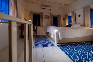a bedroom with a bed and a blue rug at Authentic Bodrum House in Bodrum City